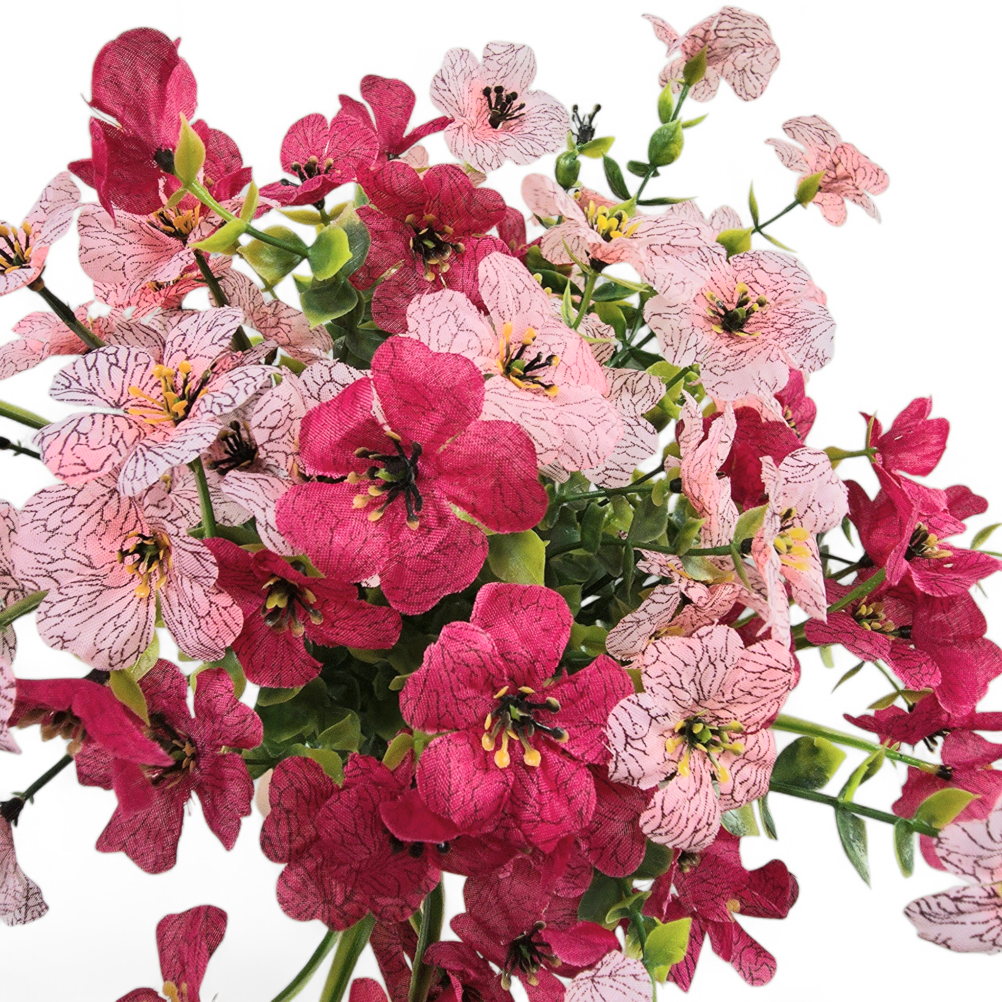 Bouquet of pink and cerise flowers with green leaves on a white background