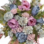 Bouquet of pink, blue, and green flowers held by a hand on a white background