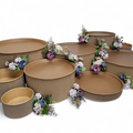 Cardboard bins with floral arrangements on a white background