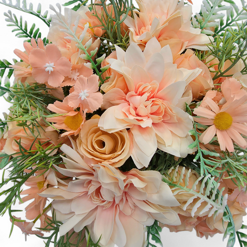 Bouquet of artificial flowers with peach and white colors on a white background