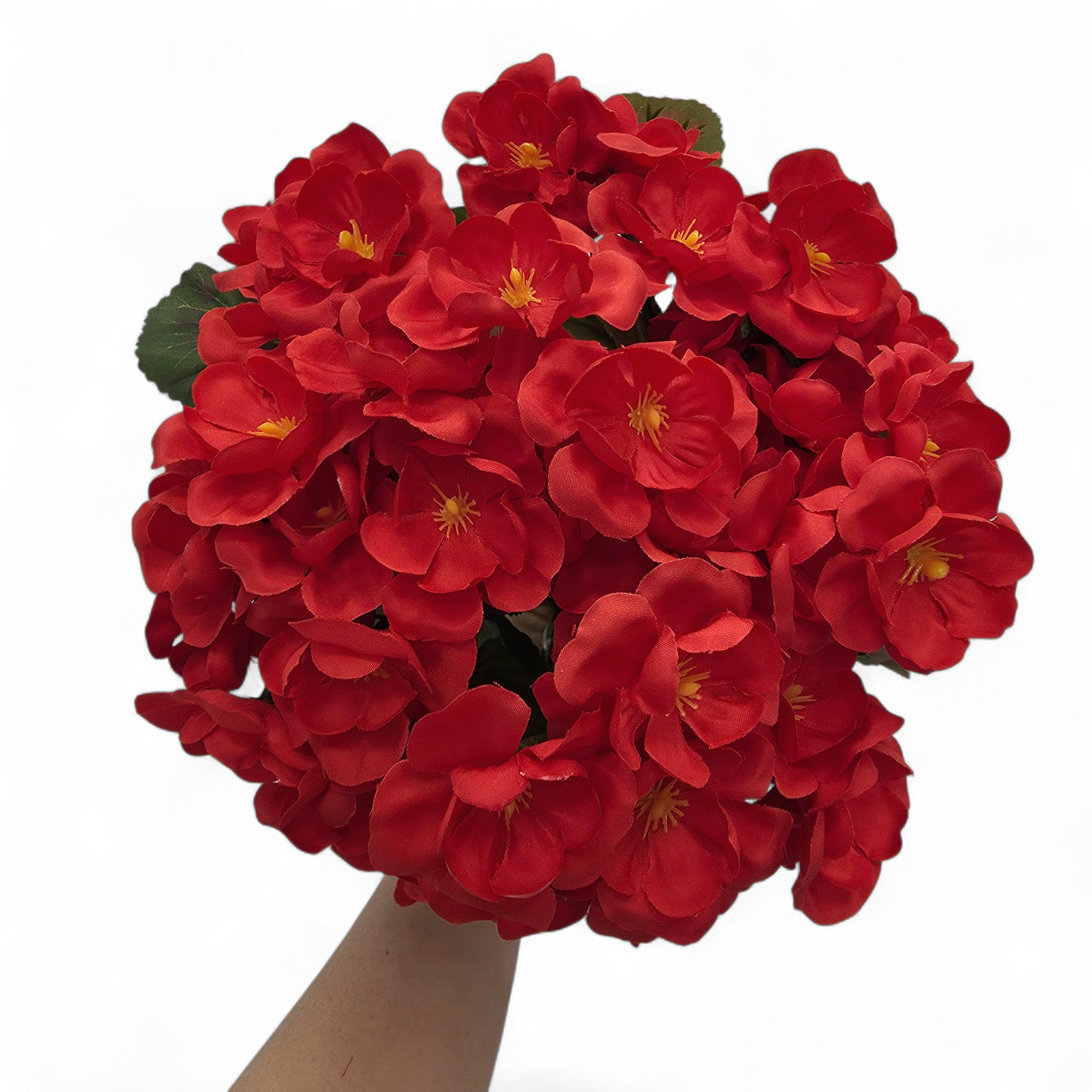 Bouquet of red flowers with green leaves on a white background
