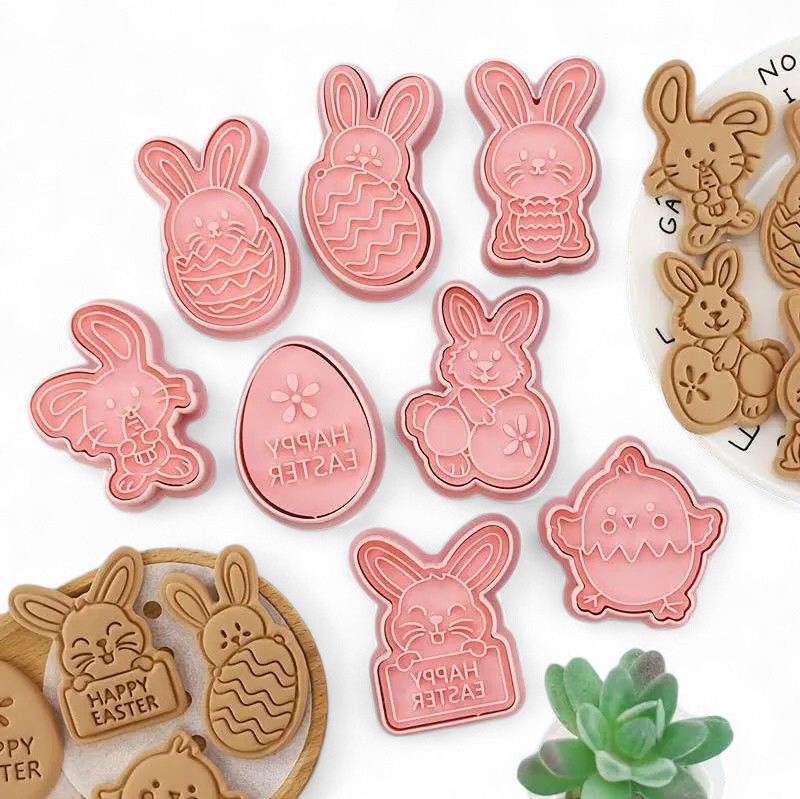 Collection of Easter-themed cookie cutters in pink and brown on a white background.