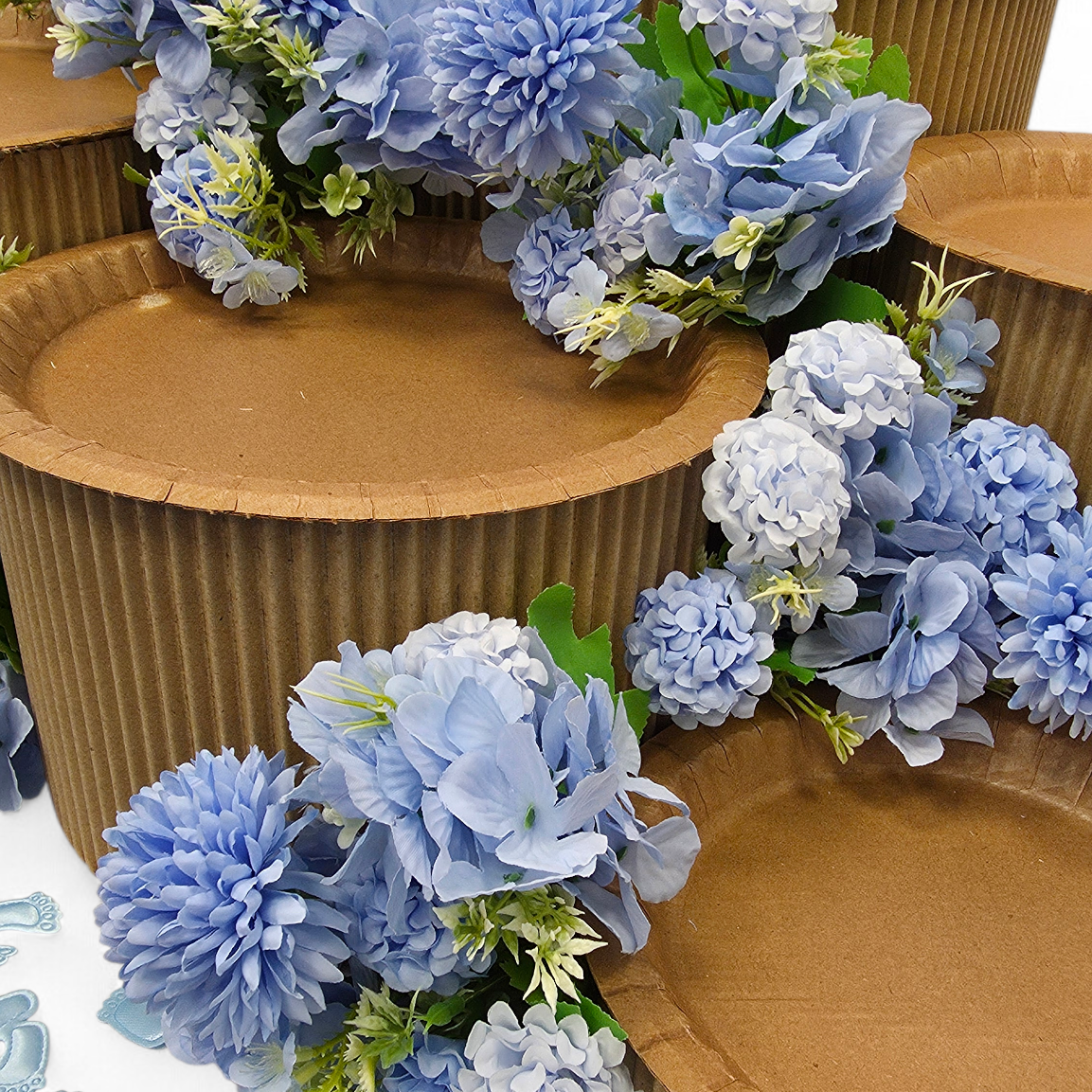 Decorative blue flowers on grazing table kit with a white background.