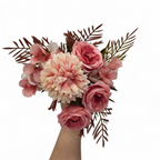 Bouquet of pink and white flowers with green leaves on a white background