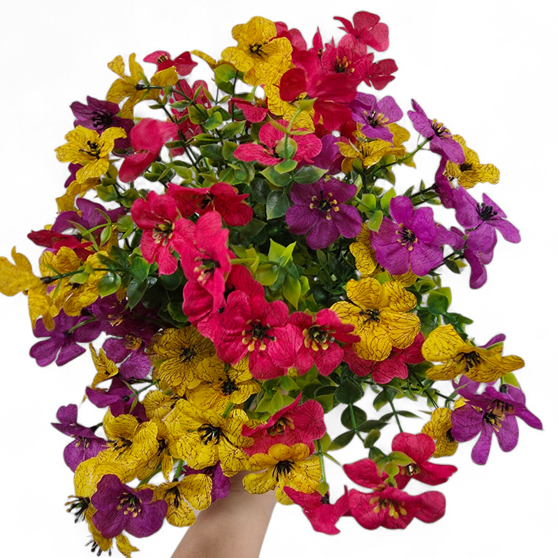 Bouquet of purple yellow and pink flowers held by a hand on a white background
