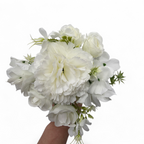 Bouquet of white flowers held by a hand on a white background