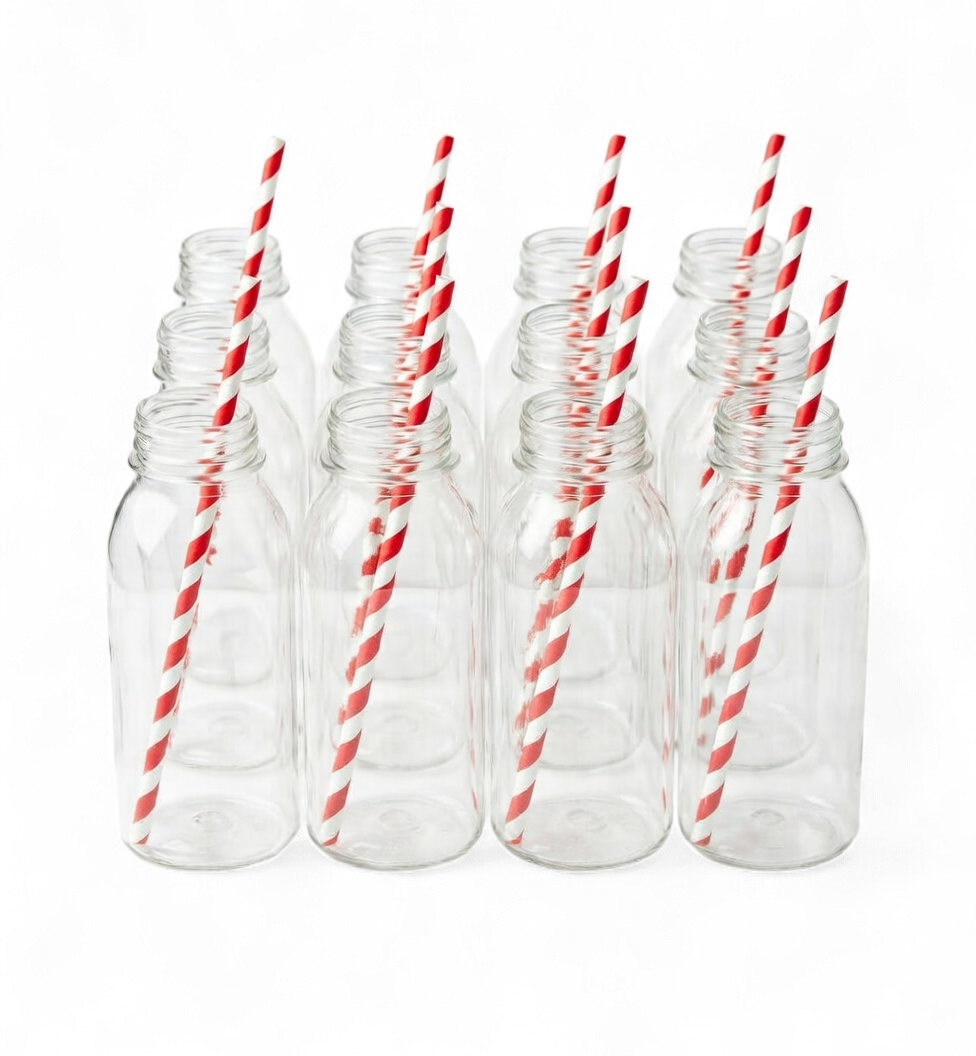 Set of clear plastic bottles with red and white striped straws on a white background